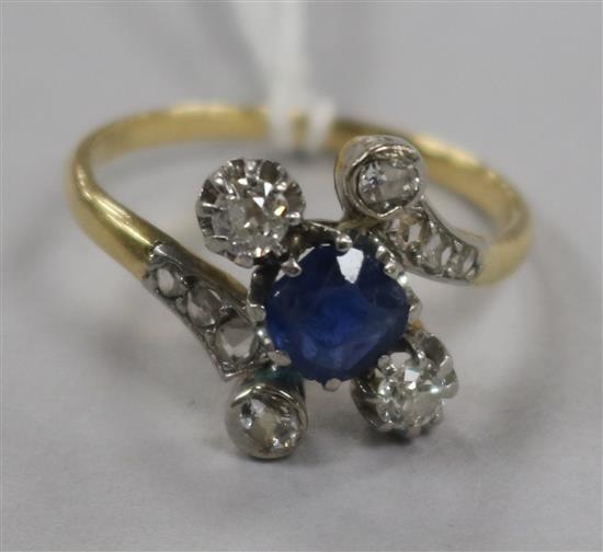 An early 20th century gold, sapphire and diamond dress ring, with diamond set shoulders, size P.